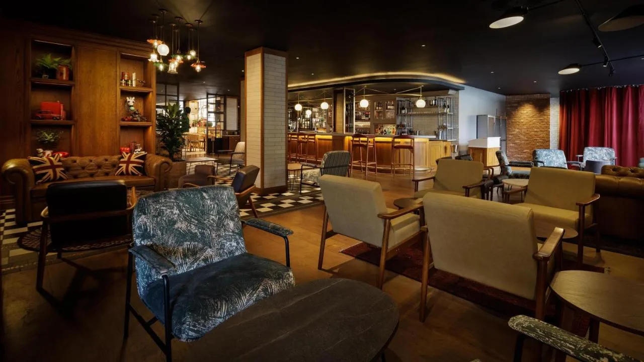 a restaurant with chairs and tables and a bar at DoubleTree by Hilton Bath in Bath